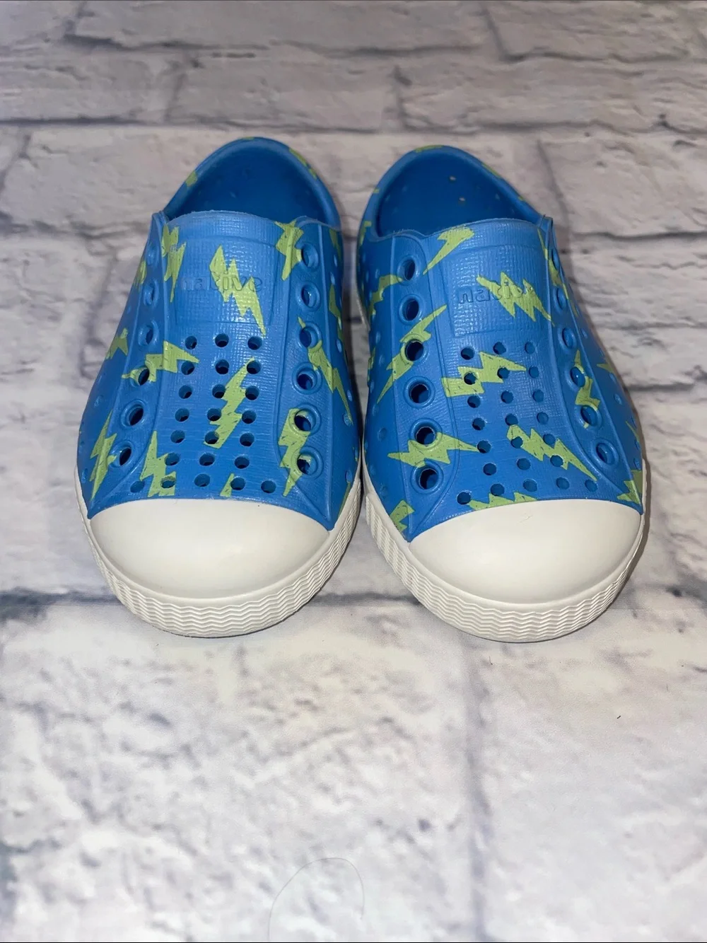 Native Jefferson Blue Slip-On with Neon Lightning Bolts. Size 5